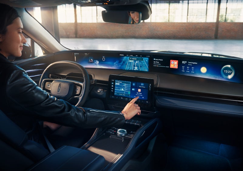 The driver of a 2024 Lincoln Nautilus® SUV interacts with the center touchscreen. | Crossroads Lincoln of Southern Pines in Southern Pines NC