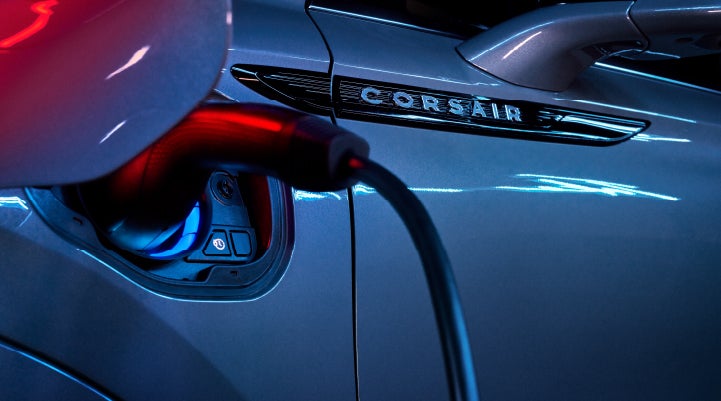 A charger plugged into the charging port of a 2024 Lincoln Corsair® Plug-in Hybrid model. | Crossroads Lincoln of Southern Pines in Southern Pines NC